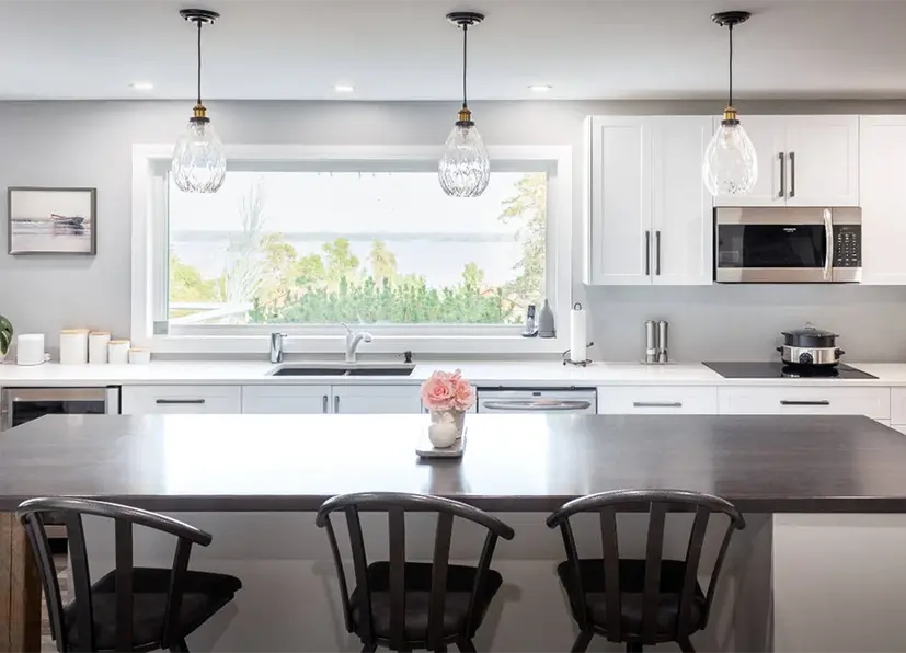 White Kitchen with Brown island countertop and black stools