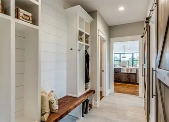 White mudroom with wooden benches