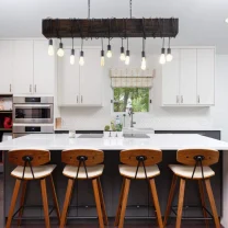 White kitchen design hanging lights and brown stools